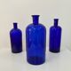 Trio of apothecary bottles in cobalt blue glass