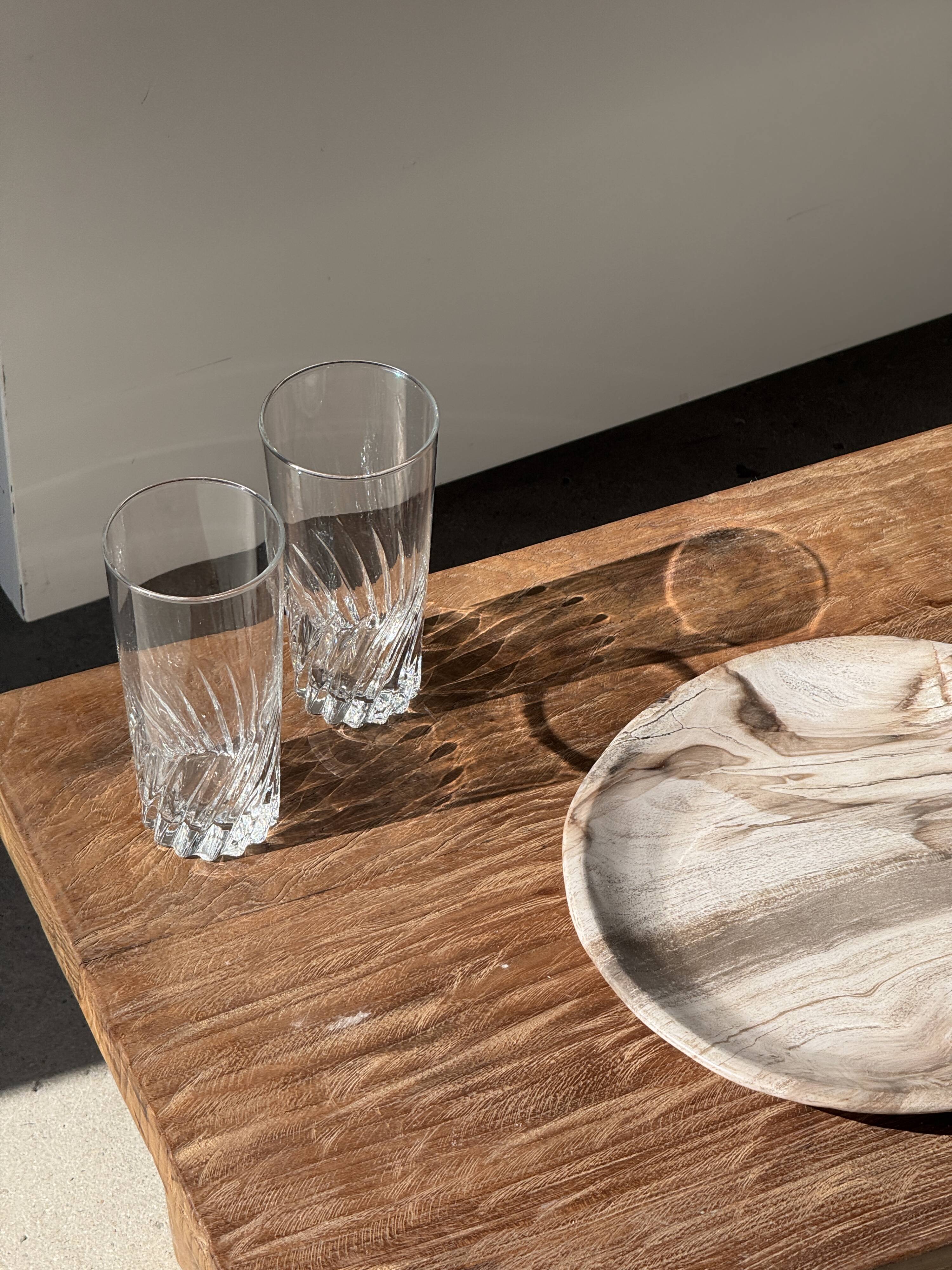 Tray, circular dish or plate made of white striped grey petrified wood.