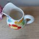 Old small jug, handmade ceramic milk pot with hand-painted floral decoration in the Vallauris style.
