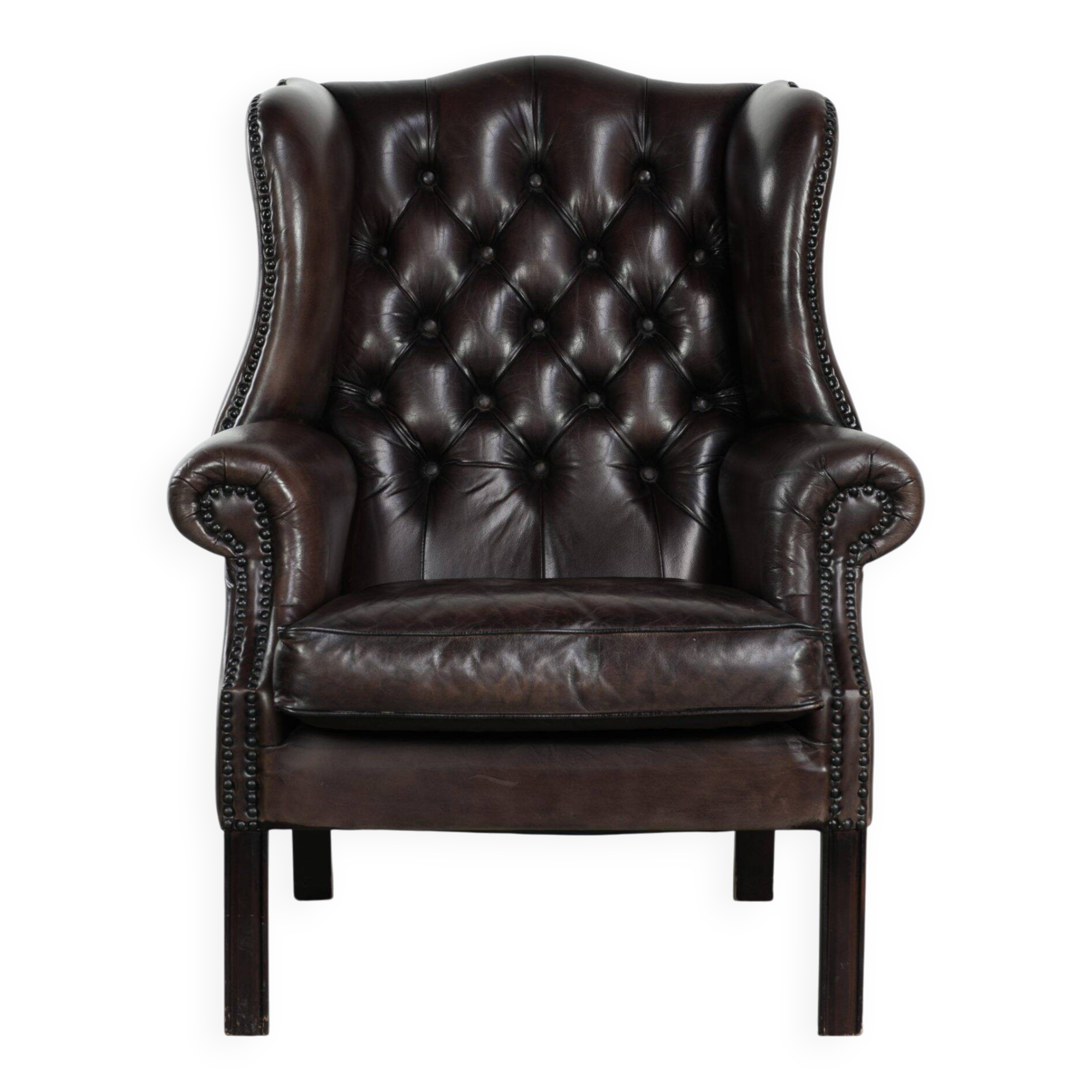 Dark brown cowhide Chesterfield wingback armchair in classic English style