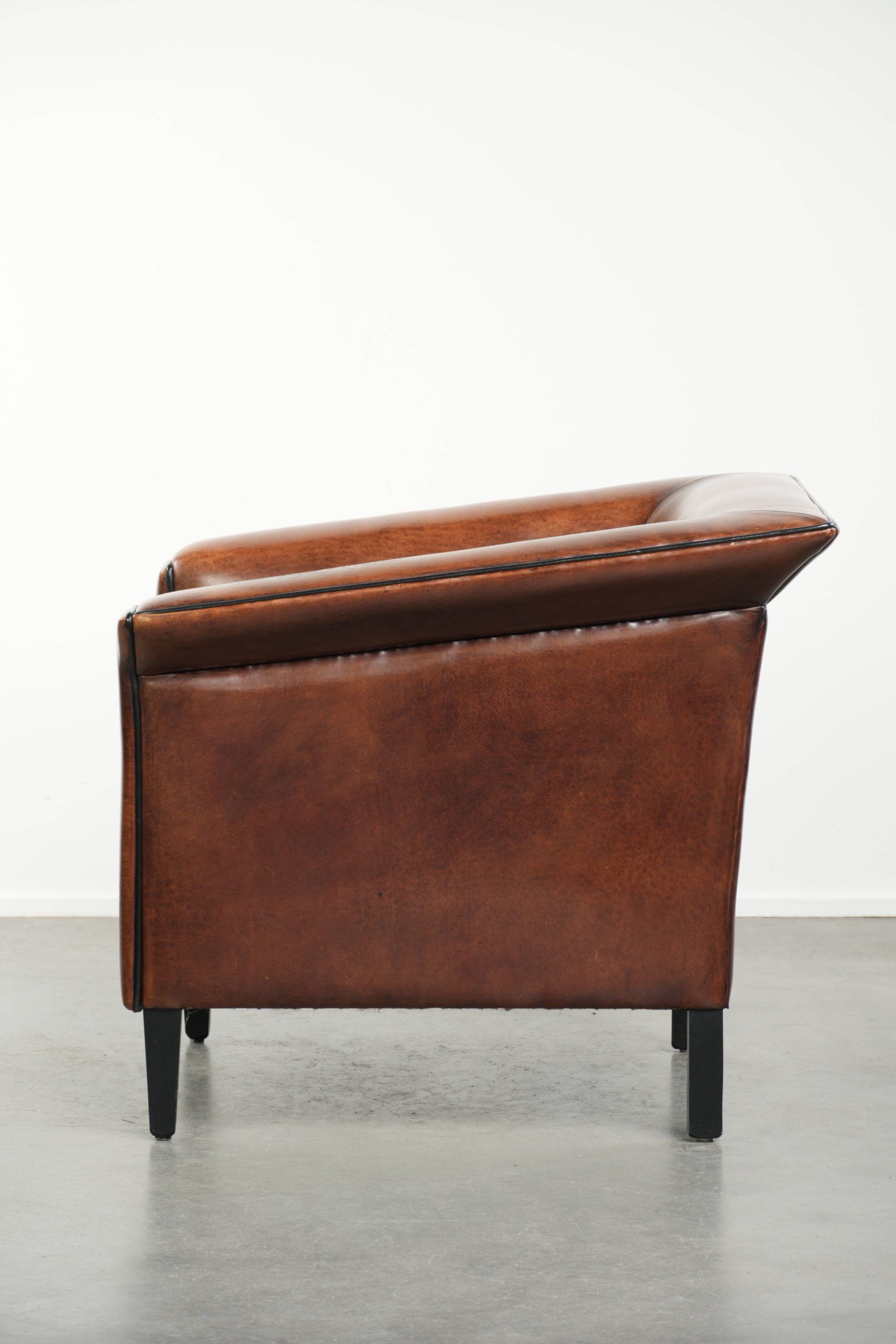 Sleek sheepskin Art Deco design armchair with black piping