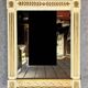 D'après Versace : miroir style Consulat en bois laqué et doré