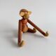 Teak monkey figurine
