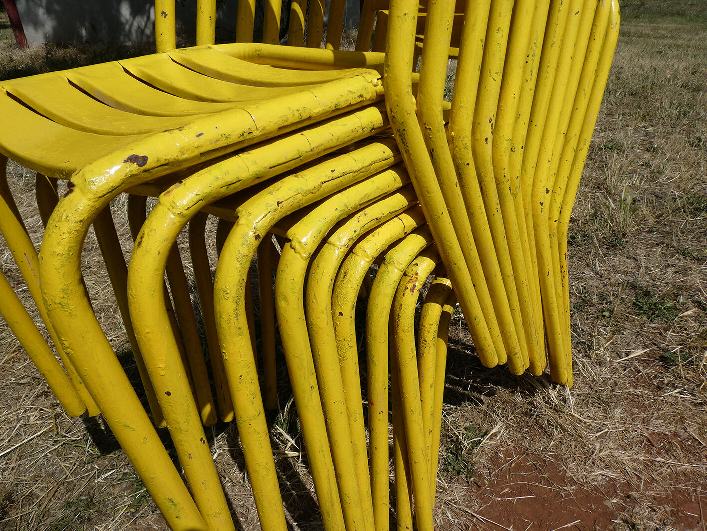 Lot of 11 yellow metallic bistro chairs from the 1950s