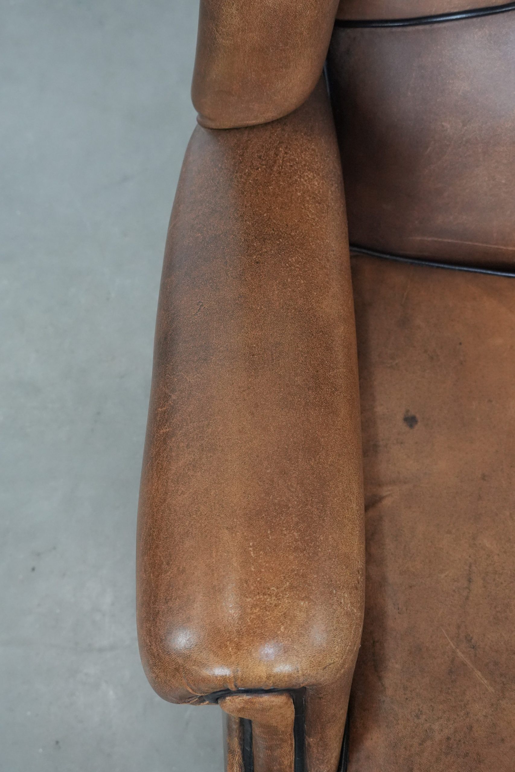 Sheepskin wingback armchair with beautiful colours in good condition