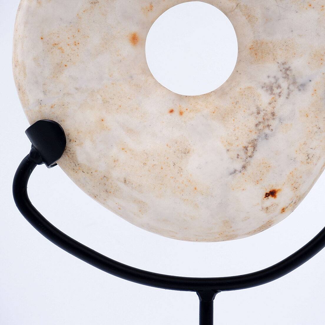 "Wamayuwa" Boiken coin in hand-carved shell mounted on a black metal stand