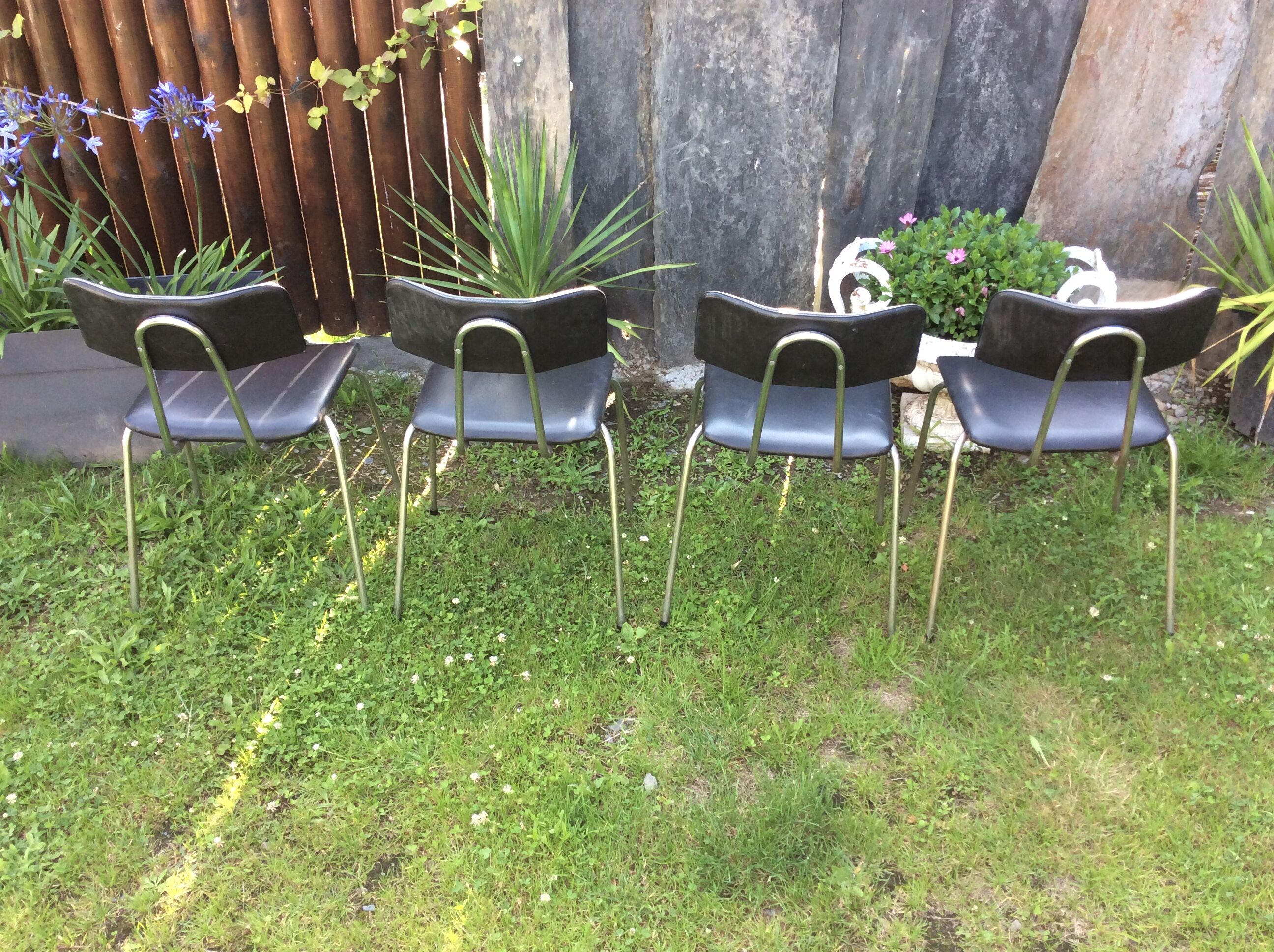 4 Chairs with chrome tubular metal base and black Skaï
