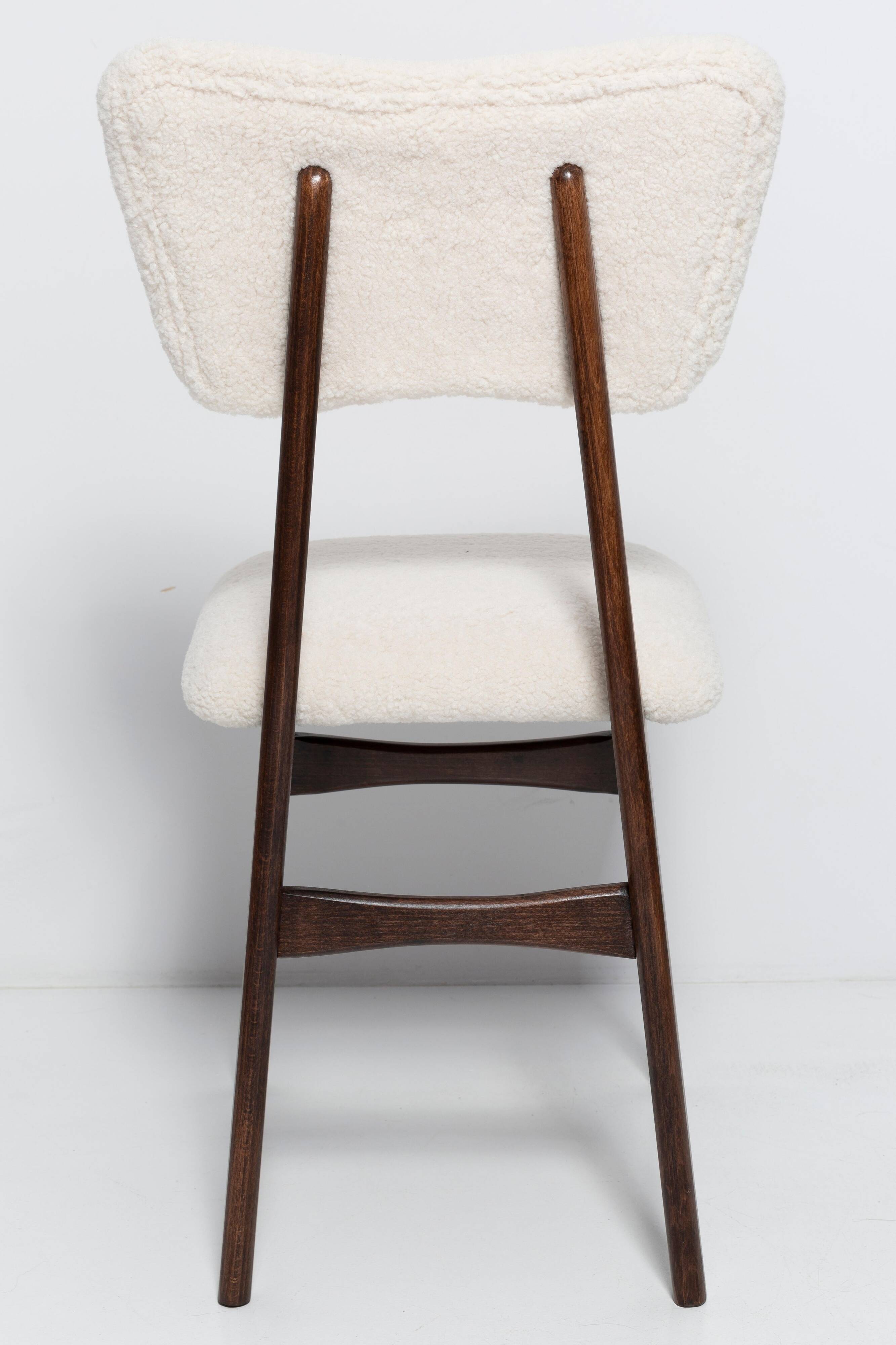 20th-century walnut and light cream boucle butterfly chair, Europe, 1960.
