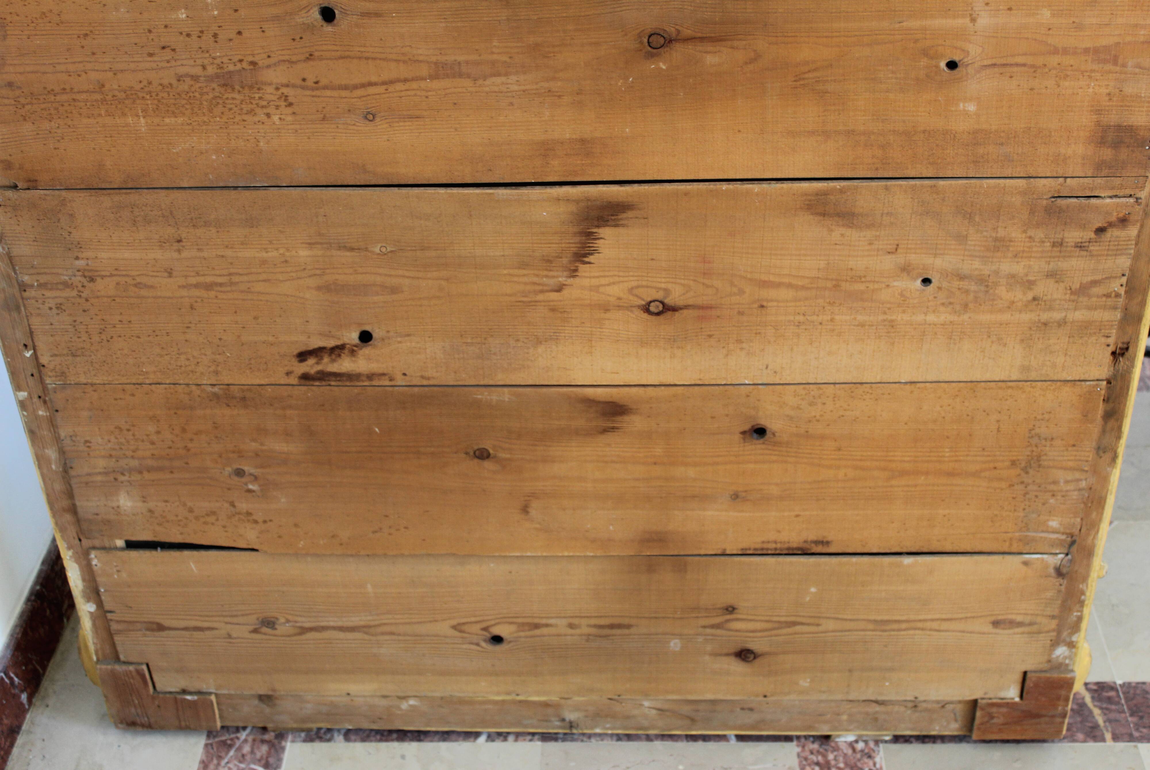 Large 19th-century wooden and gilt-studded mirror decorated with a cornucopia motif.