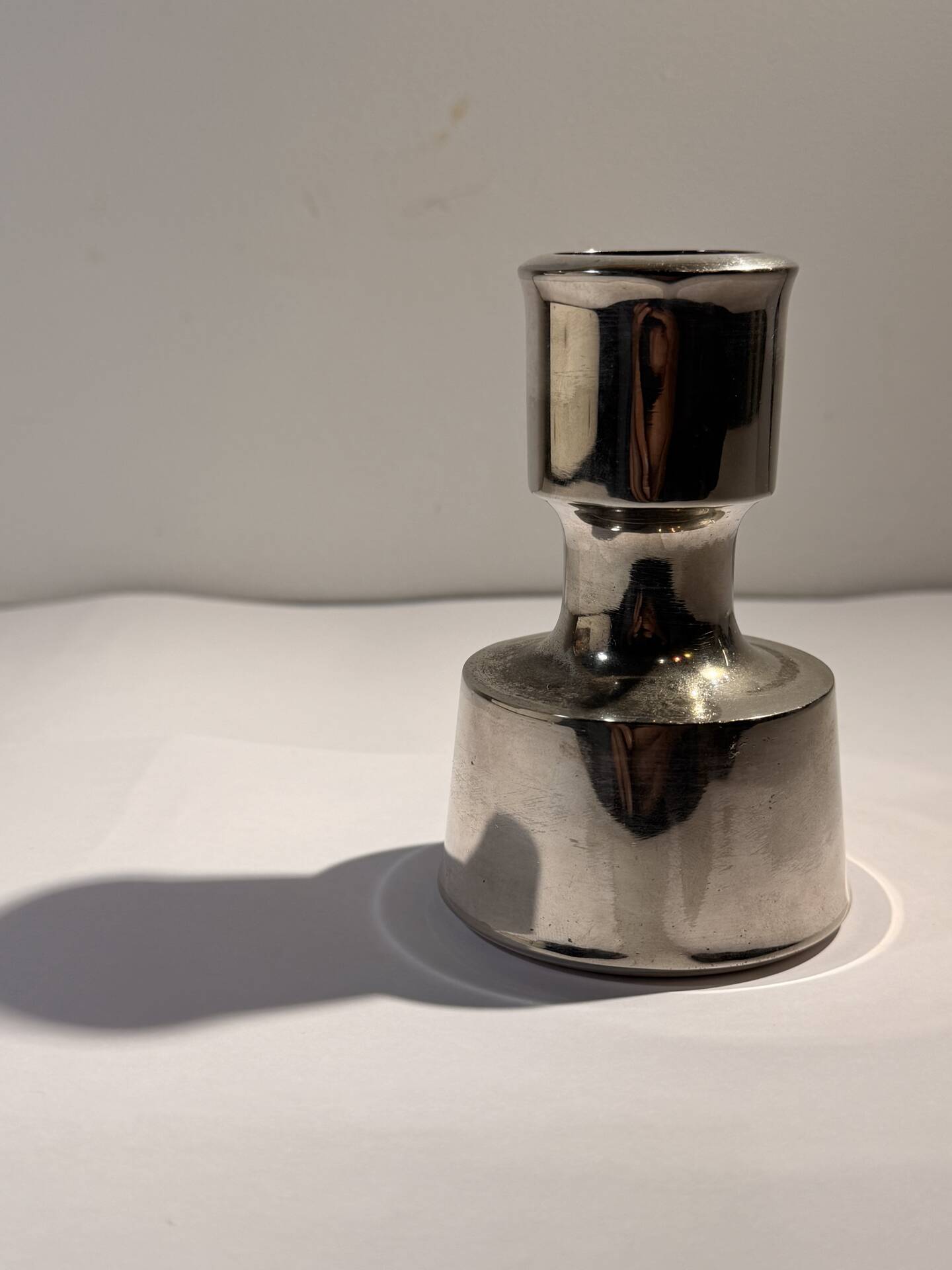 Metal candlestick by Jens Quistgaard for the brand Dansk Designs.
