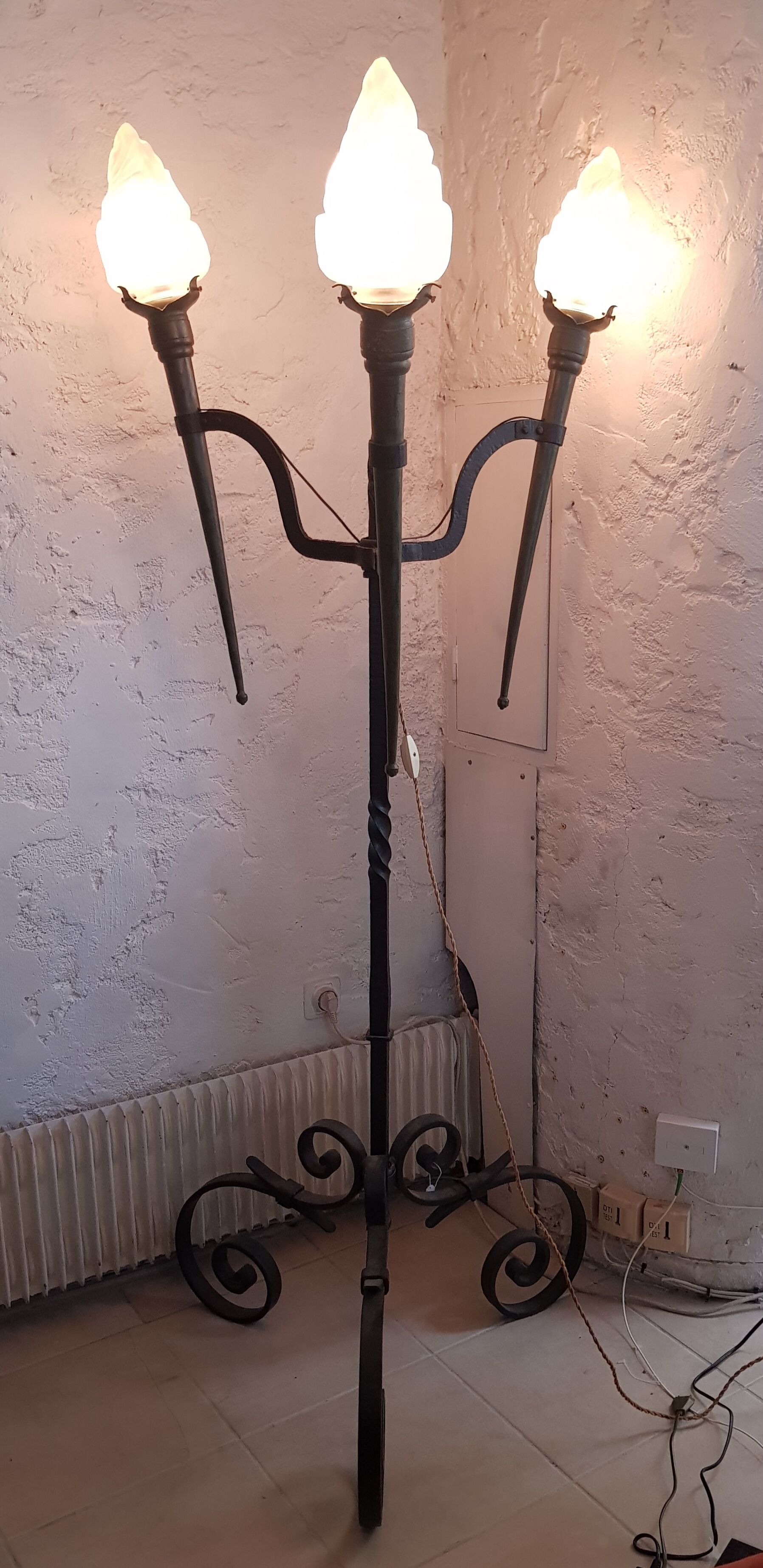 Old wrought iron tripod lamppost