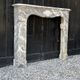 Louis XV fireplace in grey Ardennes marble, a floral basket in white marble, late 18th century.