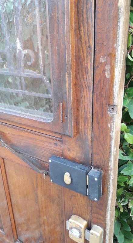 Oak entrance door and its frame and transom, wrought iron gates