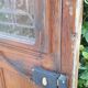 Oak entrance door and its frame and transom, wrought iron gates