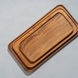 Trio of rounded rectangular trays or cups in monoxyl teak L:35