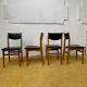 4 Scandinavian chairs in teak and black faux leather.