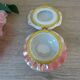 Vintage shell-shaped catchall in iridescent cream and pink ceramic.