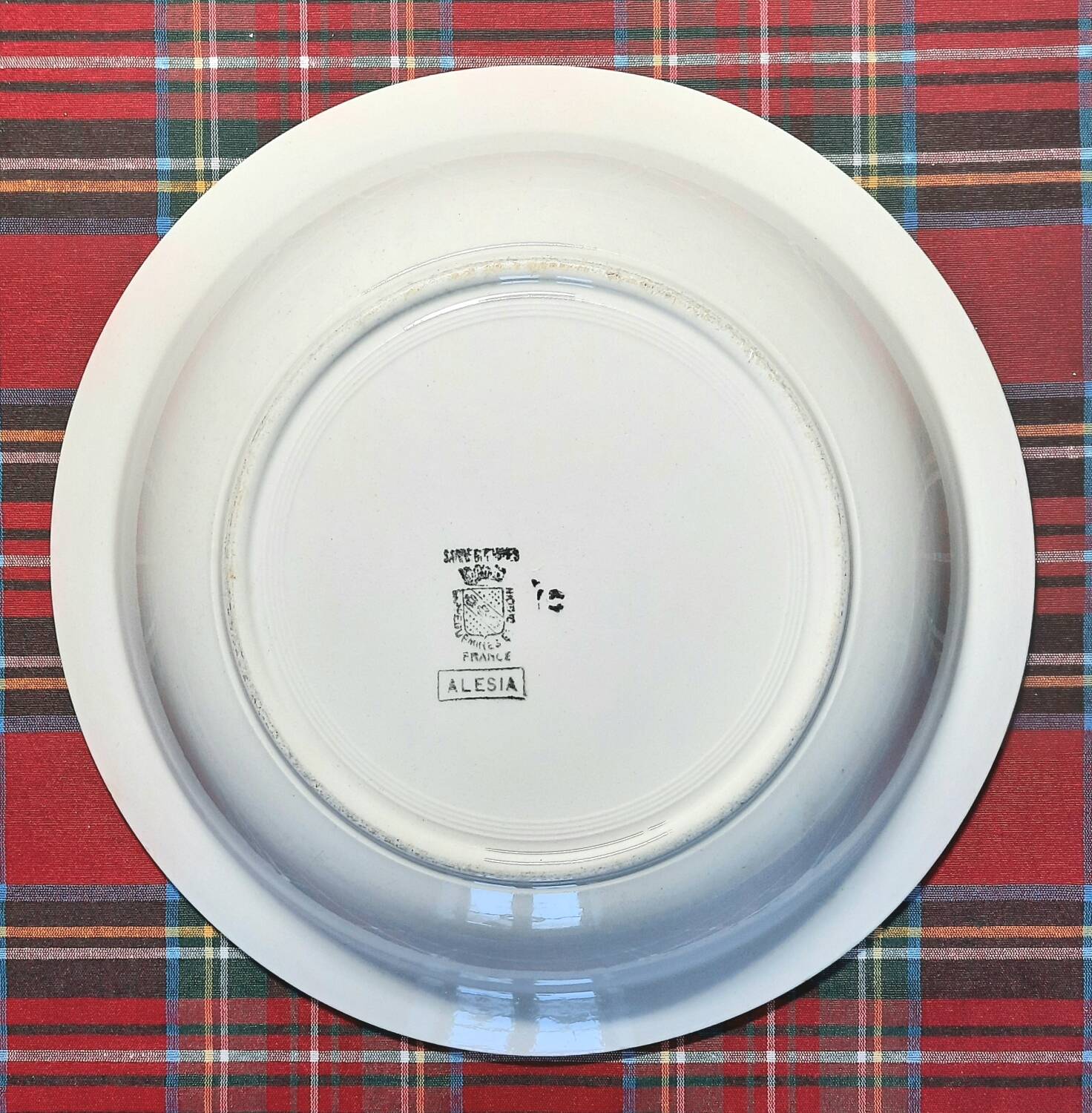 Mismatched antique flat plates in earthenware accompanied by a deep dish.