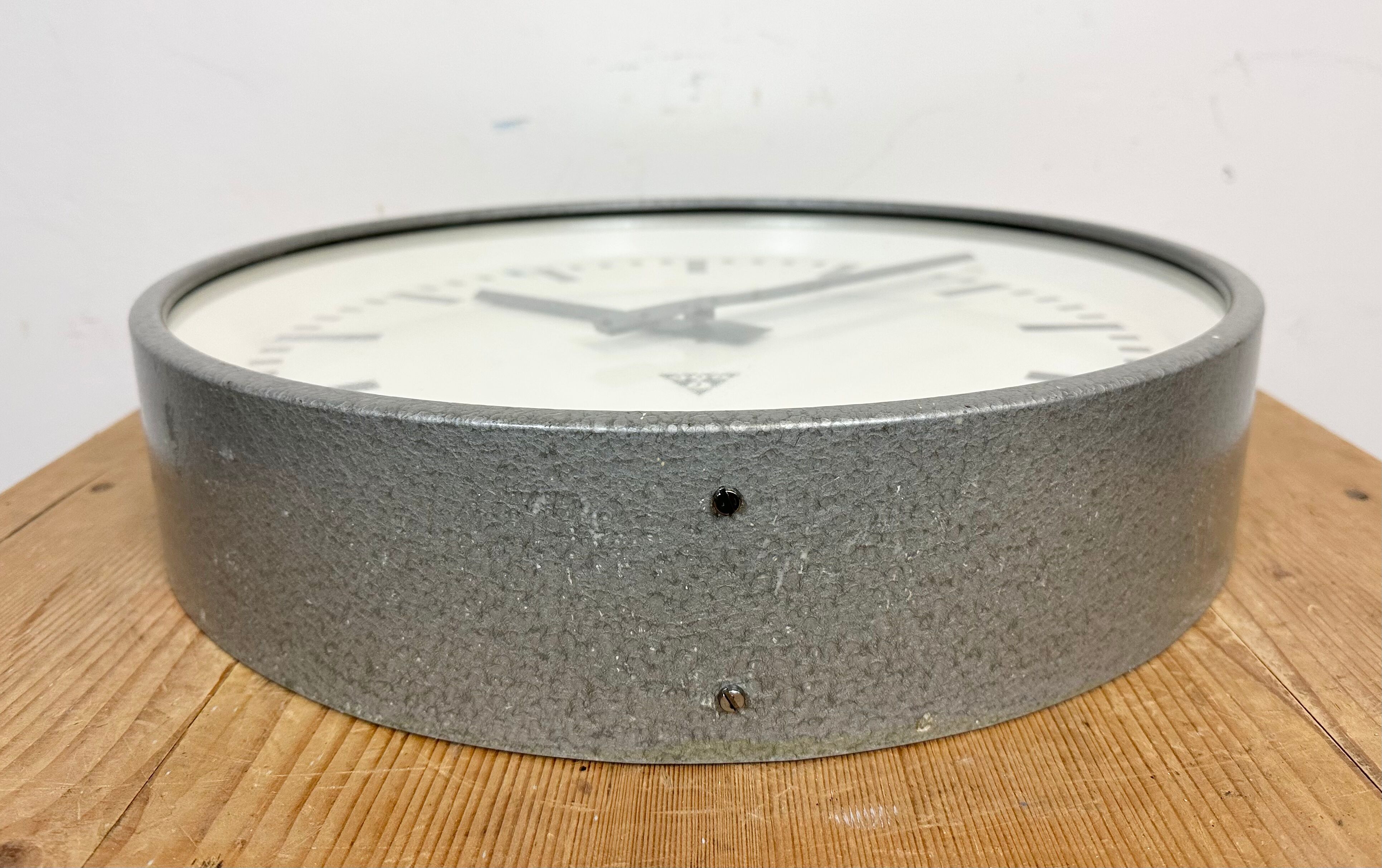 Grey industrial factory wall clock from pragotron, 1960s