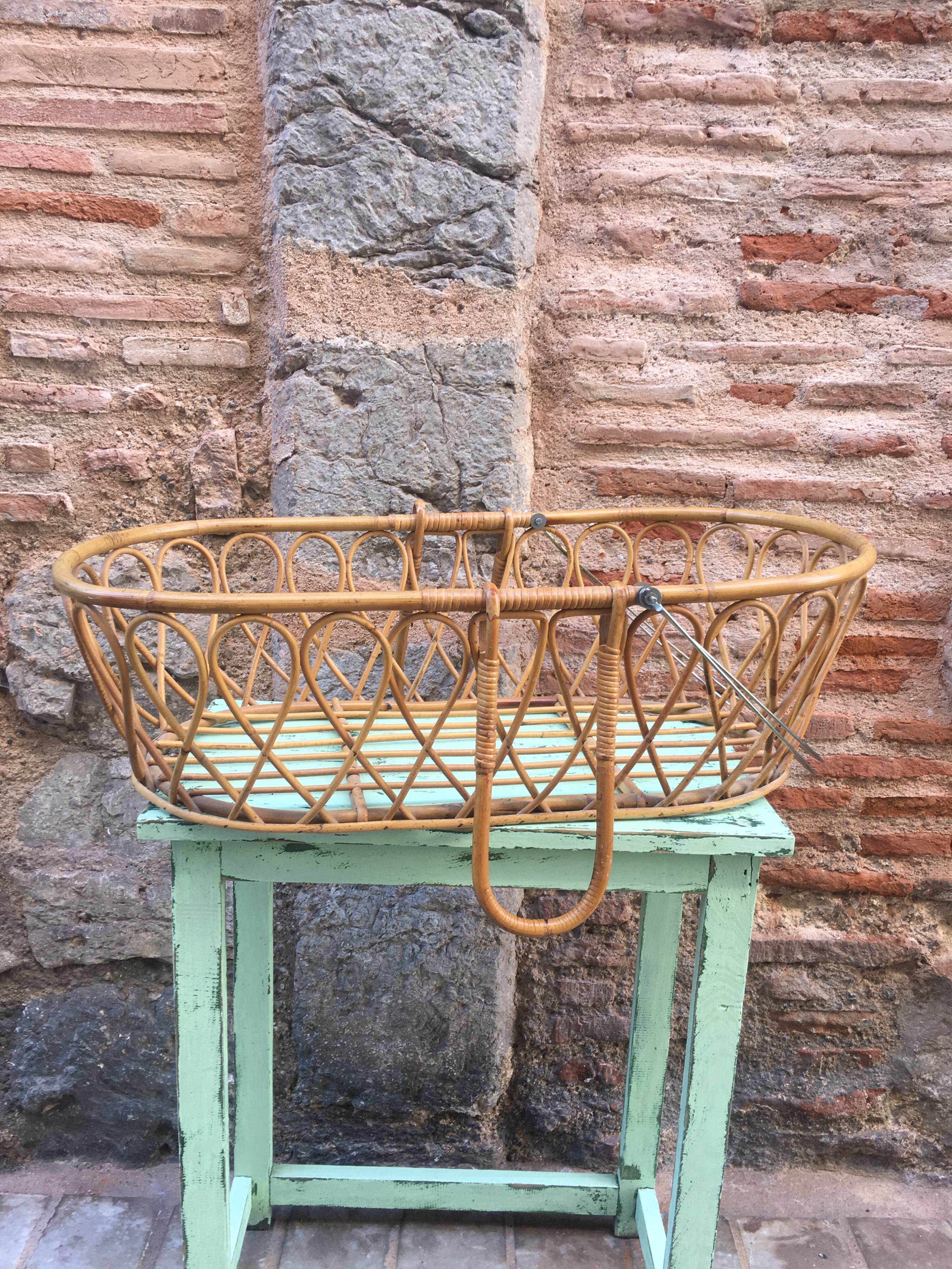 Rattan bassinet with hood arches