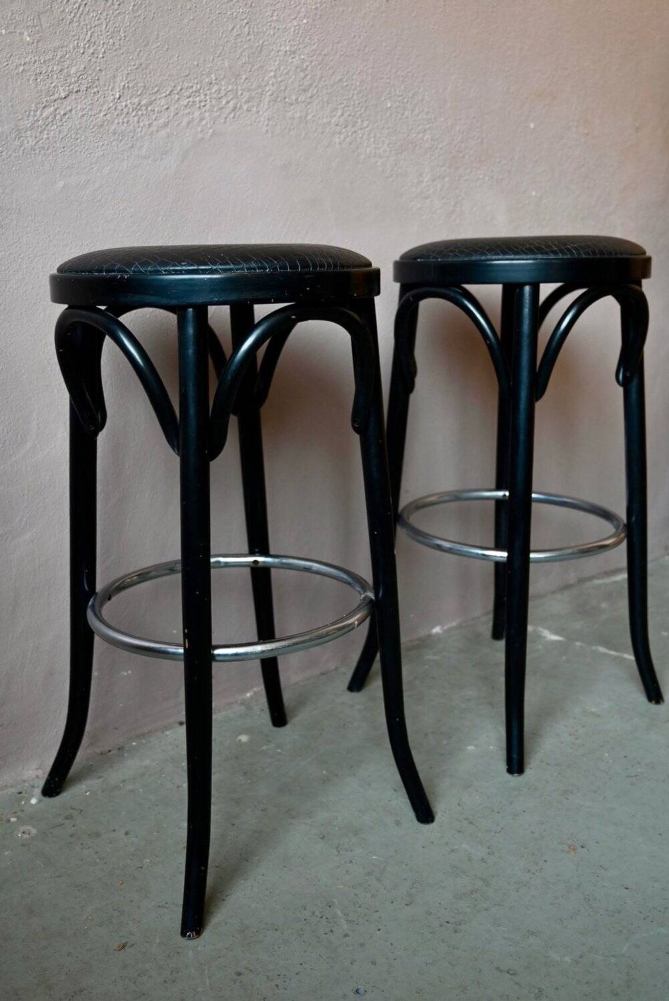 Pair of 1960s bistro bar stools in black and chrome with vinyl shell.