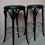 Pair of 1960s bistro bar stools in black and chrome with vinyl shell.