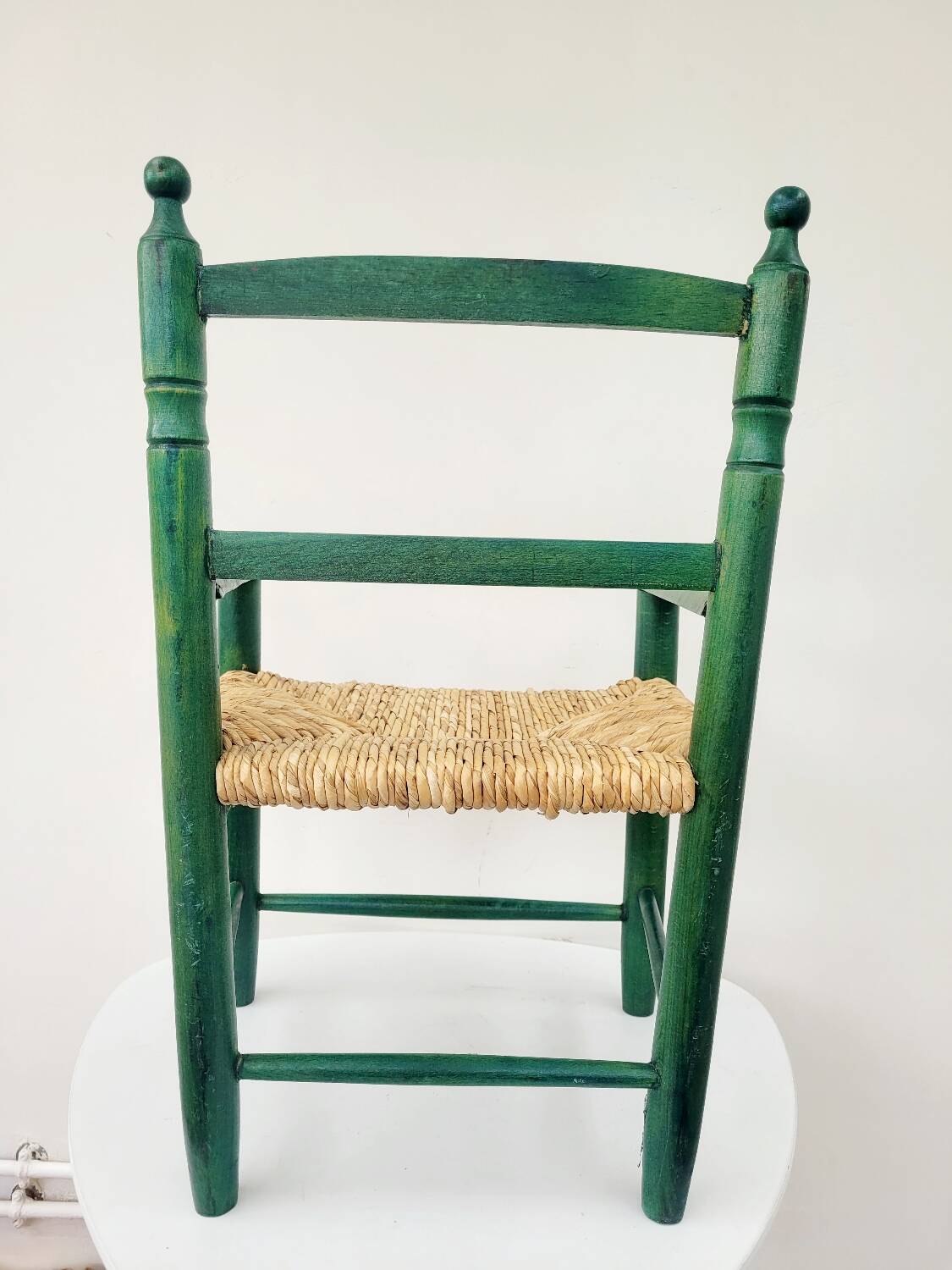Small vintage children's chair in wood and green straw