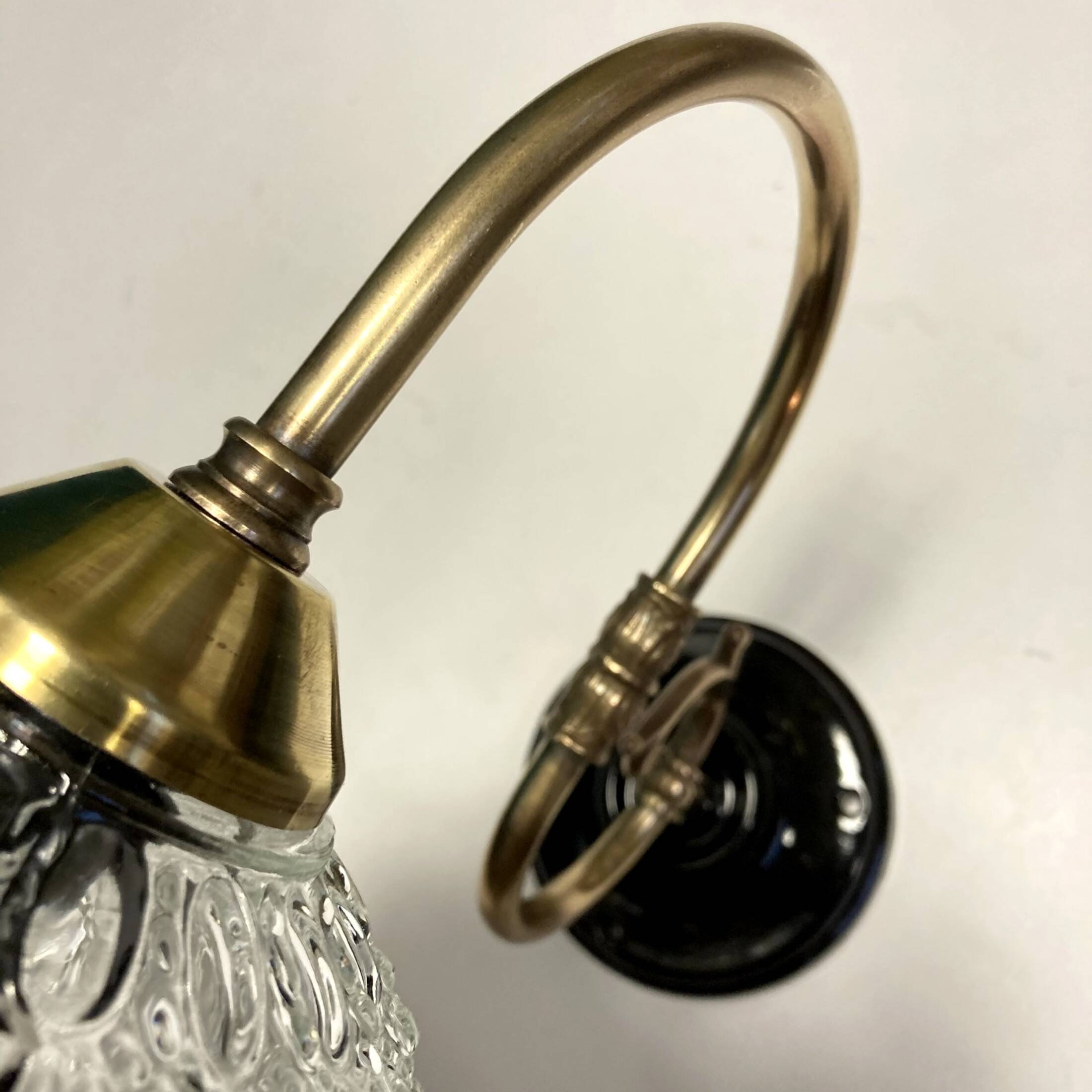 Pair of old swan neck wall lights in brass and transparent glass globe
