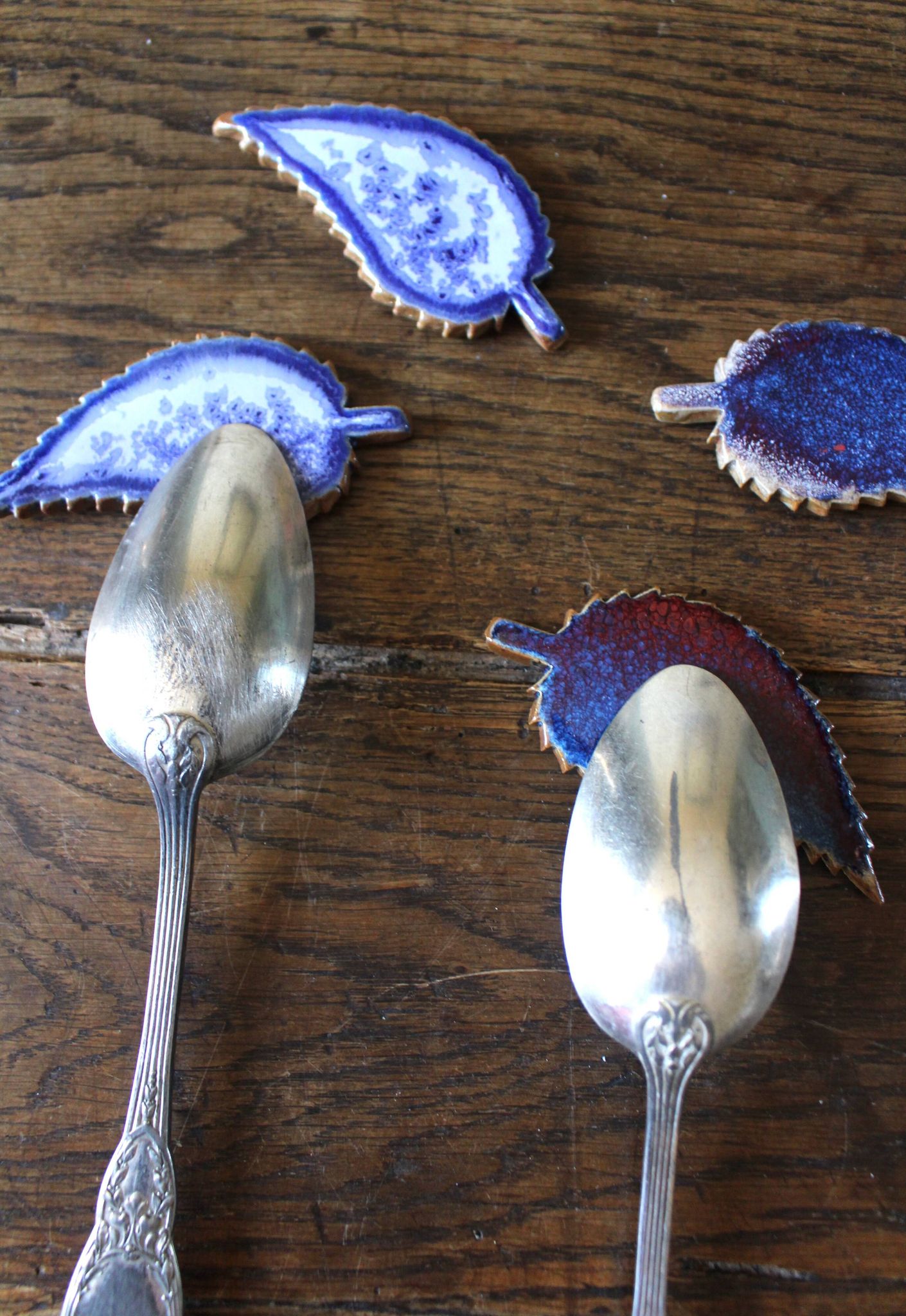 A set of 4 handcrafted pottery knife rests in blue.
