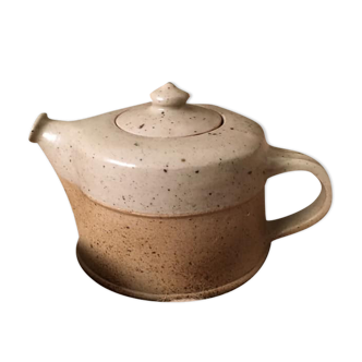 Rounded ceramic teapot in very light tones
