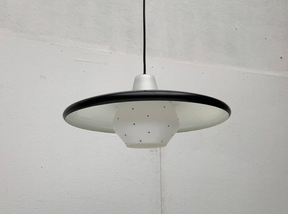 Minimalist metal and glass pendant lamp in mid-century style.