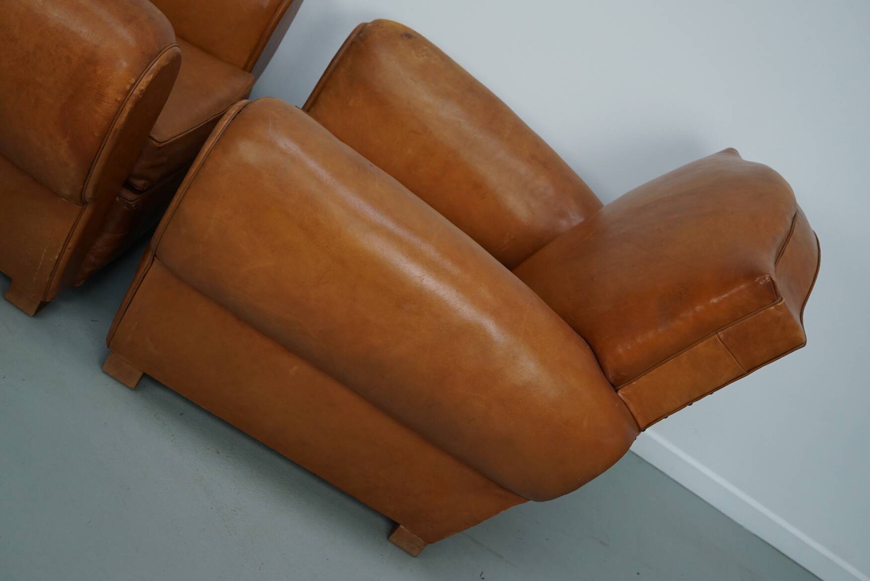 Pair of French club chairs with moustache back in cognac leather, 1950s