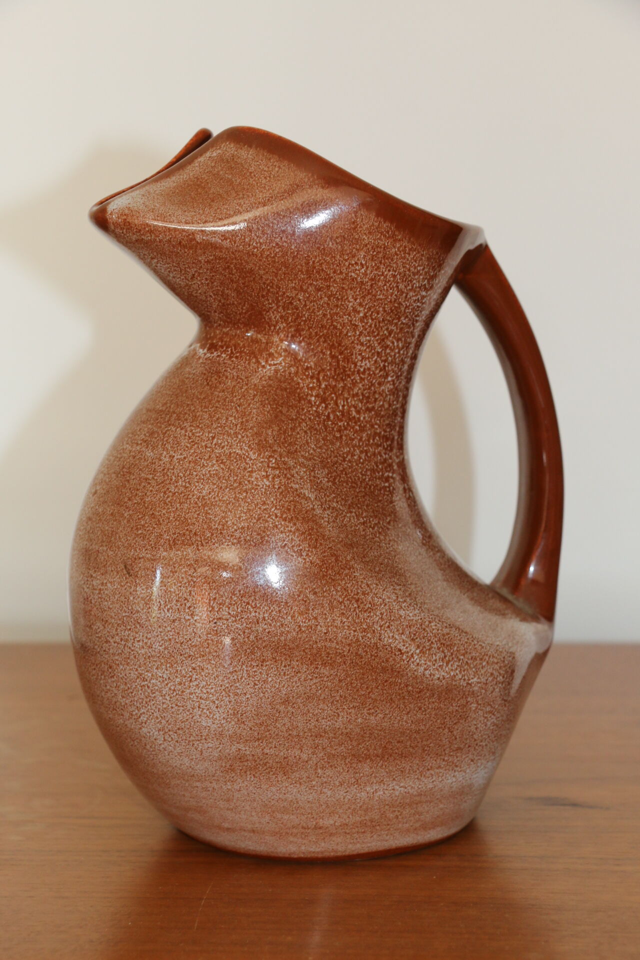 Brown painted earthenware pitcher