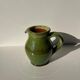 Green glazed ceramic pitcher