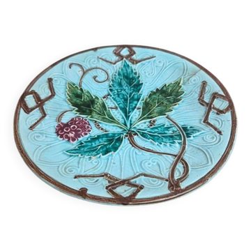 Old small compote dish in turquoise majolica with raised floral decoration.