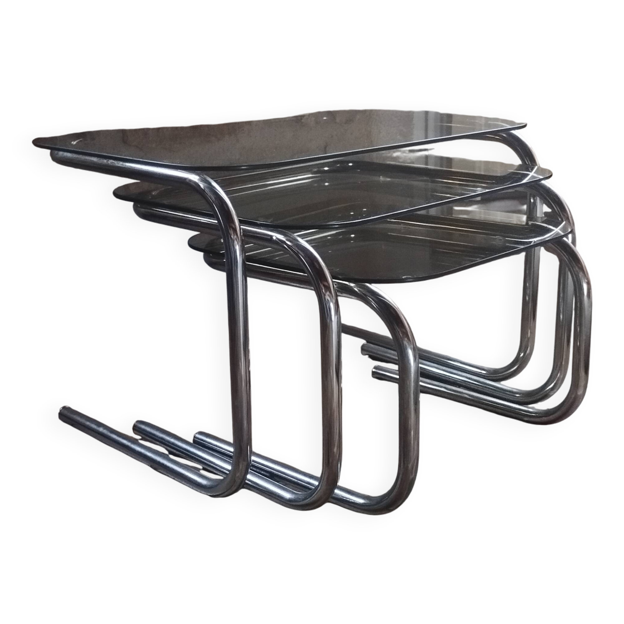 Nest of tables in glass and chrome steel.