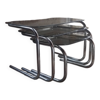 Nest of tables in glass and chrome steel.