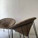 Italian basket chair in rattan and black metal, 1950s design.