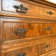 Antique walnut commode with bronze handles in the shape of a lion's mask,