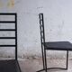 Set of 4 minimalist black steel dining chairs.