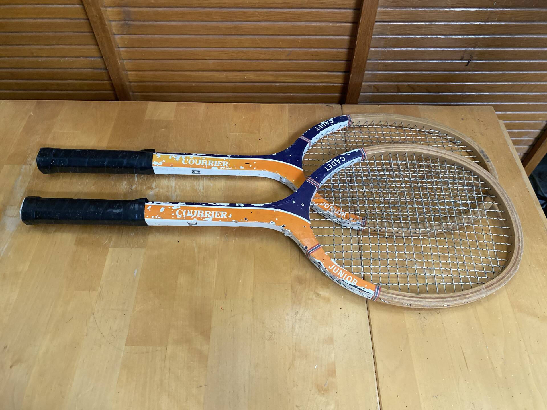 Pair of vintage wooden tennis rackets for cadet junior sport courier