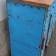 Old blue metal locker with wooden top