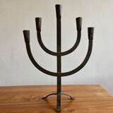Old iron candelabra shaped high time