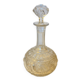 19th-century liqueur carafe in glass adorned with relief patterns.