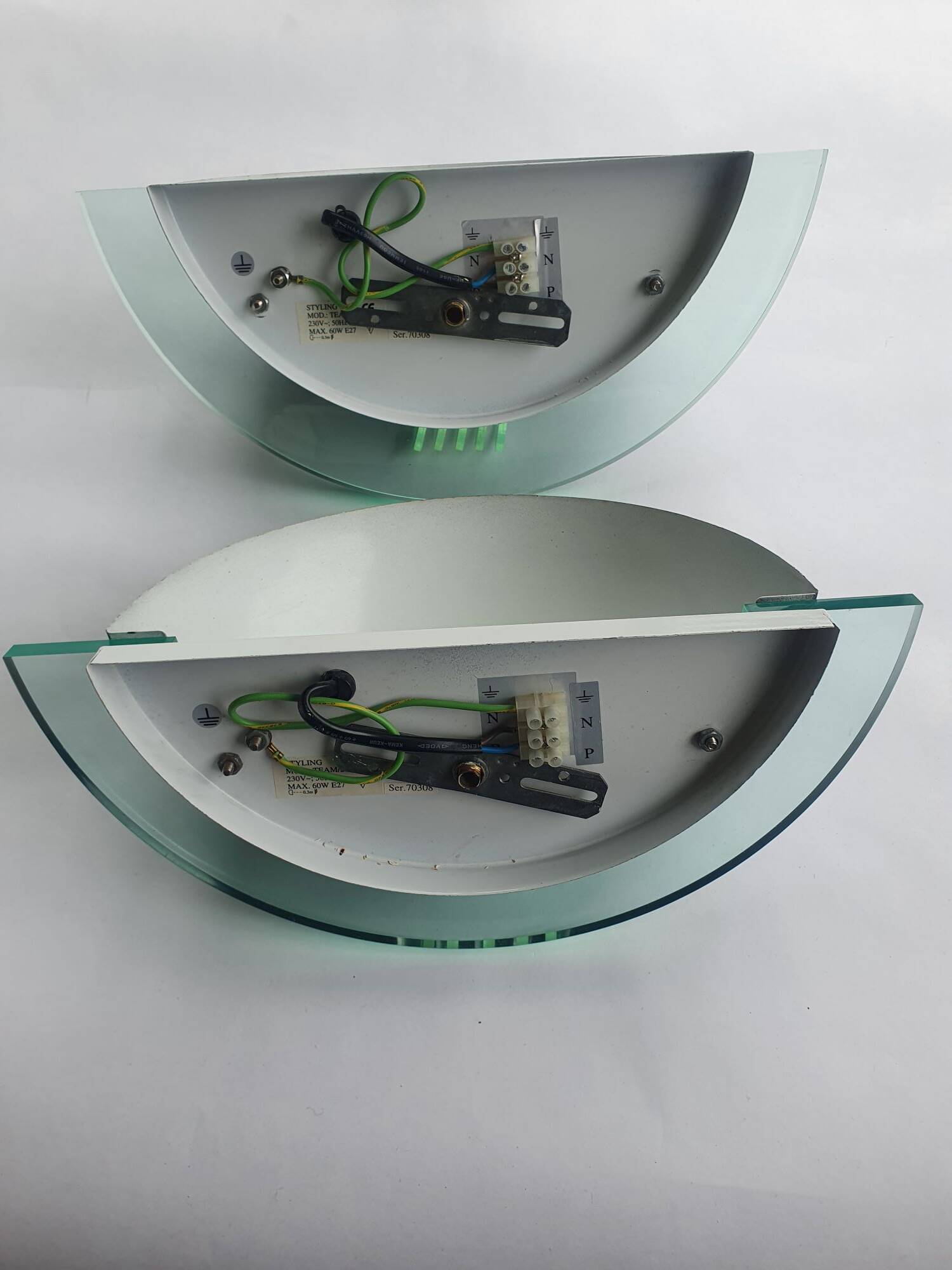 Pair of vintage black metal and plexiglass half-moon wall lights