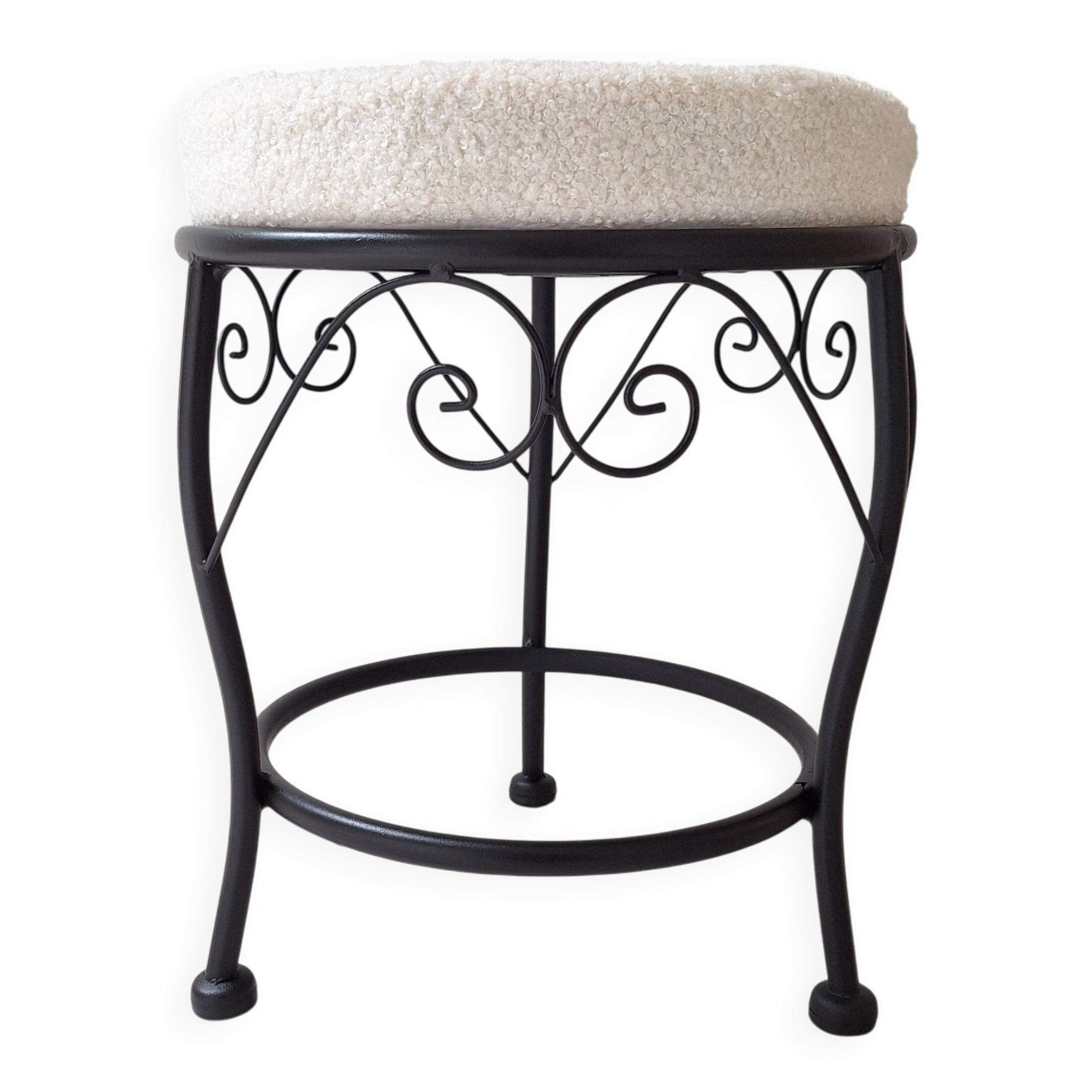 Black iron stool/pouf with its boucle fabric cushion.