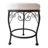 Black iron stool/pouf with its boucle fabric cushion.