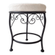 Black iron stool/pouf with its boucle fabric cushion.