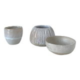Meeting of three artist's ceramic objects including two pots and a cream covered bowl