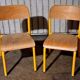 Pair of school chairs, wood and yellow metal, industrial decor.